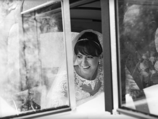 black and white white getting out of vintage car, staffordshire wedding photographer, heath house weddings