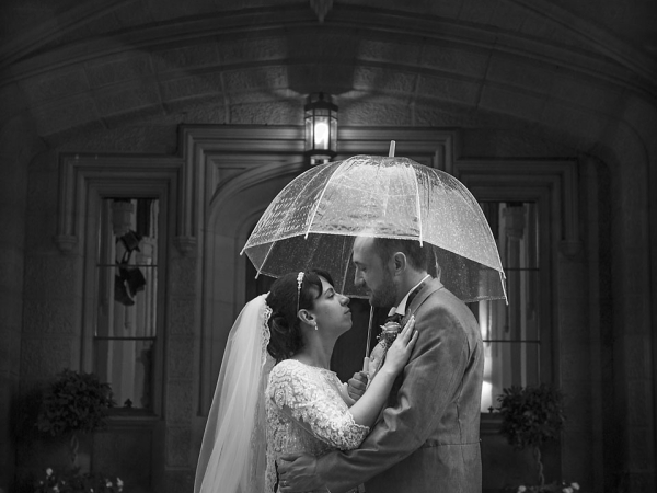 bride and groom under an umbrella in the rain, staffordshire wedding photographer, heath house weddings