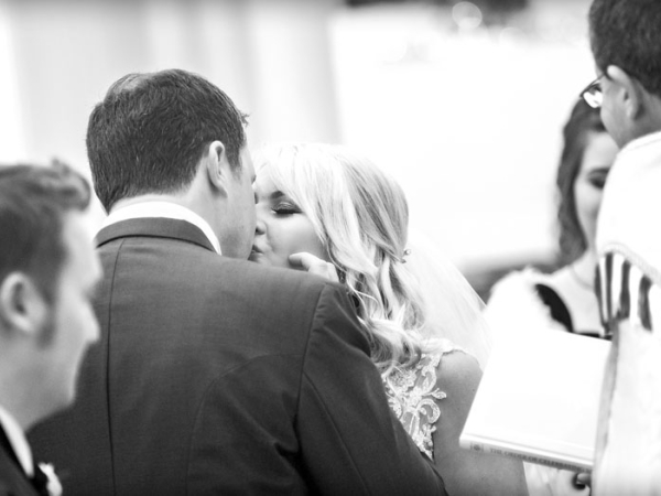 bride and groom first kiss, black and white, cheshire wedding photographer, crewe hall