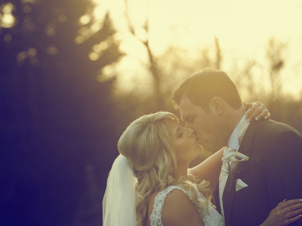 bride and groom kissing at sunset, cheshire wedding photographer, crewe hall