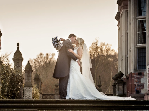 bride and groom kissing, sepia, cheshire wedding photographer, crewe hall