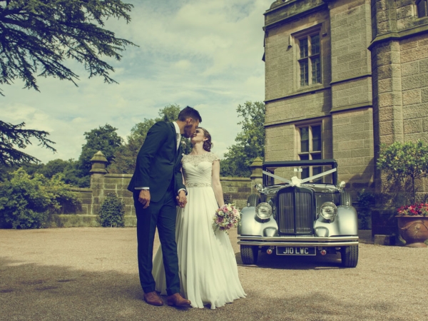 bride and groom kiss by vintage car, staffordshire wedding photographer, heath house weddings