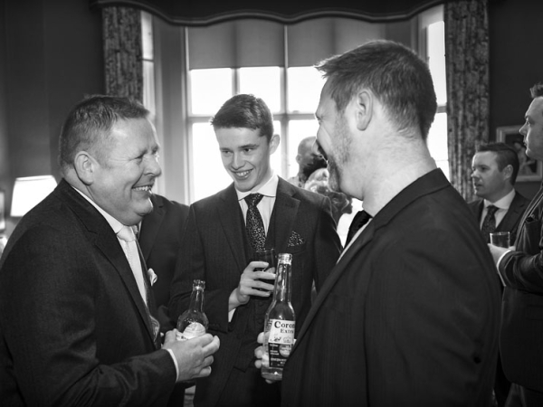 black and white groom and best man laughing, staffordshire wedding photographer, heath house weddings
