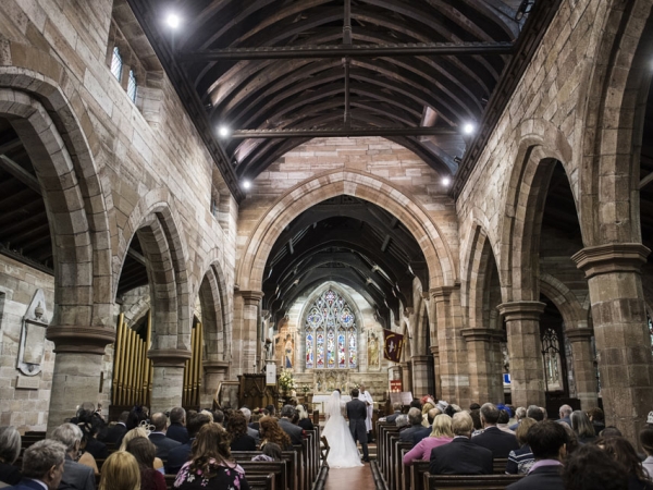 bride and groom saying vows in church, cheshire wedding photographer