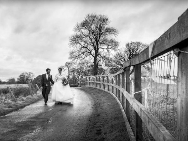black and white countryside bride and groom holding hands, cheshire wedding photographer