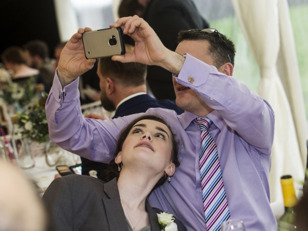 guest taking a photo on a smartphone, cheshire wedding photographer