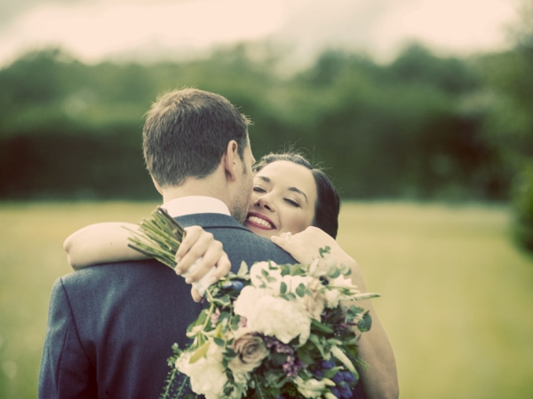 bride and groom hug, smiling, gloucestershire wedding photographer, cripps barn