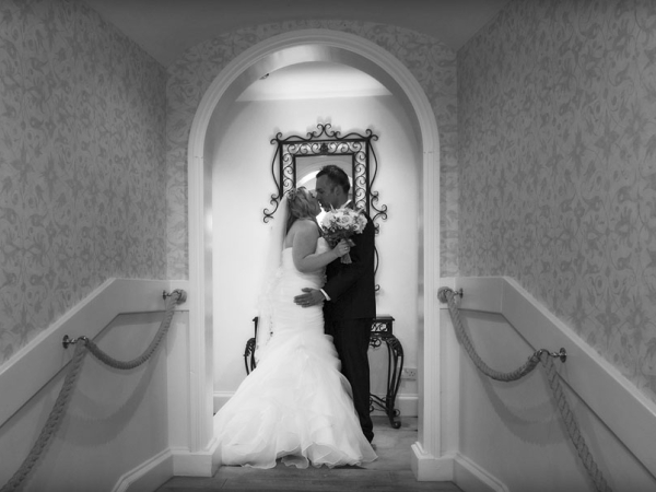 bride and groom kiss in a corridor, staffordshire wedding photographer, alrewas hayes weddings