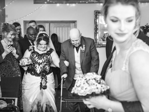 bride and father walking down aisle, wedding photographer in wales
