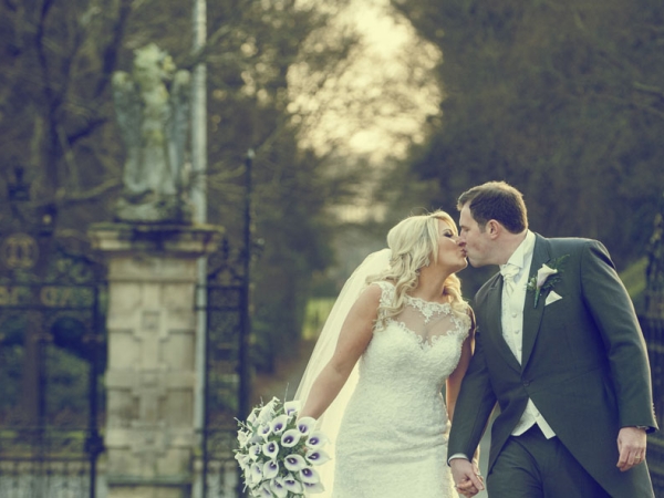 bride and groom kissing, walking up a driveway, cheshire wedding photographer, crewe hall