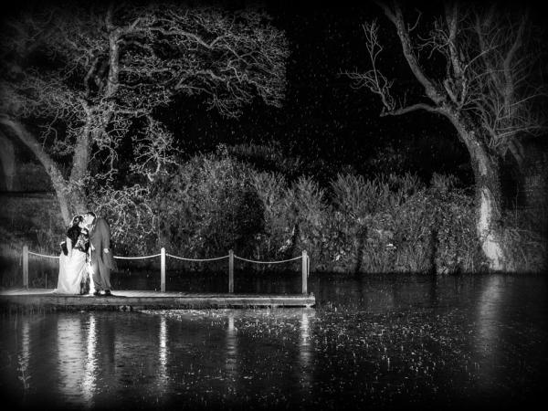 bride and groom by a lake at night, wedding photographer in wales