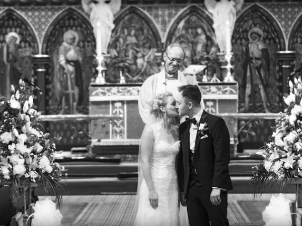 bride and groom first kiss, cheshire wedding photographer, all saints church thelwall