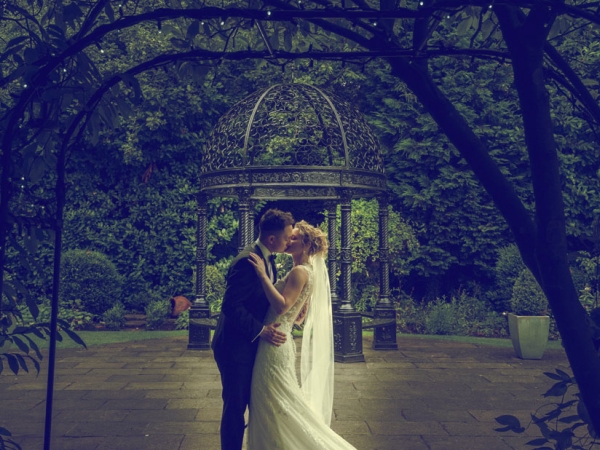 bride and groom kiss gazebo, cheshire wedding photographer, statham lodge hotel