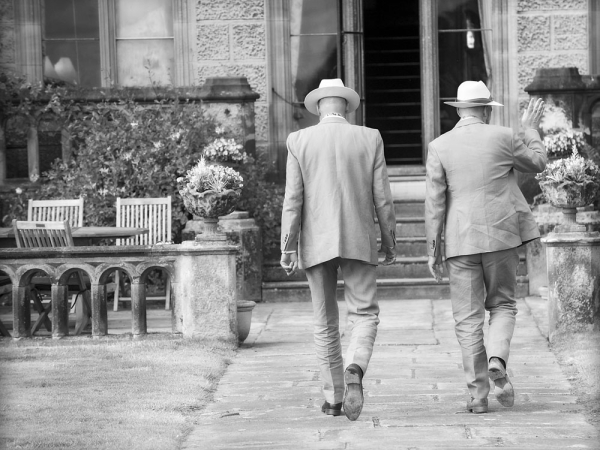 black and white grooms holding hands, staffordshire wedding photographer, heath house weddings