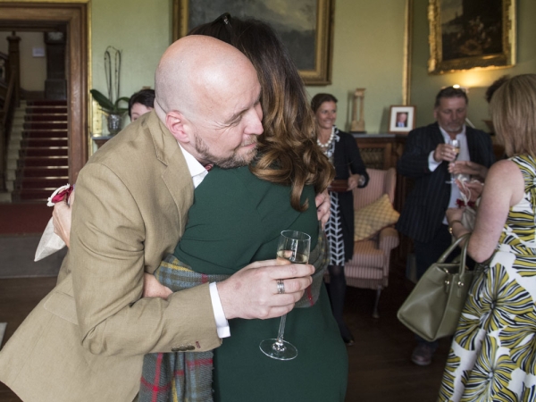 groom hugging guest, staffordshire wedding photographer, heath house weddings