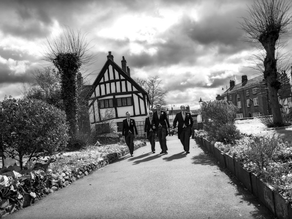 black and white groom and best man walking to church, warwickshire wedding photographer, Ansty Hall