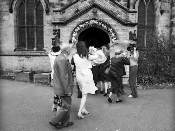 black and white guests entering church, warwickshire wedding photographer, Ansty Hall