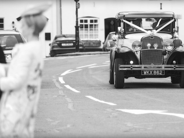 black and white bride arriving in vintage car, warwickshire wedding photographer, Ansty Hall