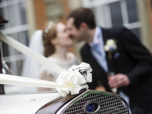 bride and groom kiss by a vintage car, warwickshire wedding photographer, Ansty Hall