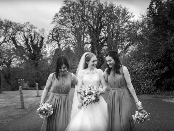 black and white bride and bridesmaids approaching reception, warwickshire wedding photographer, Ansty Hall